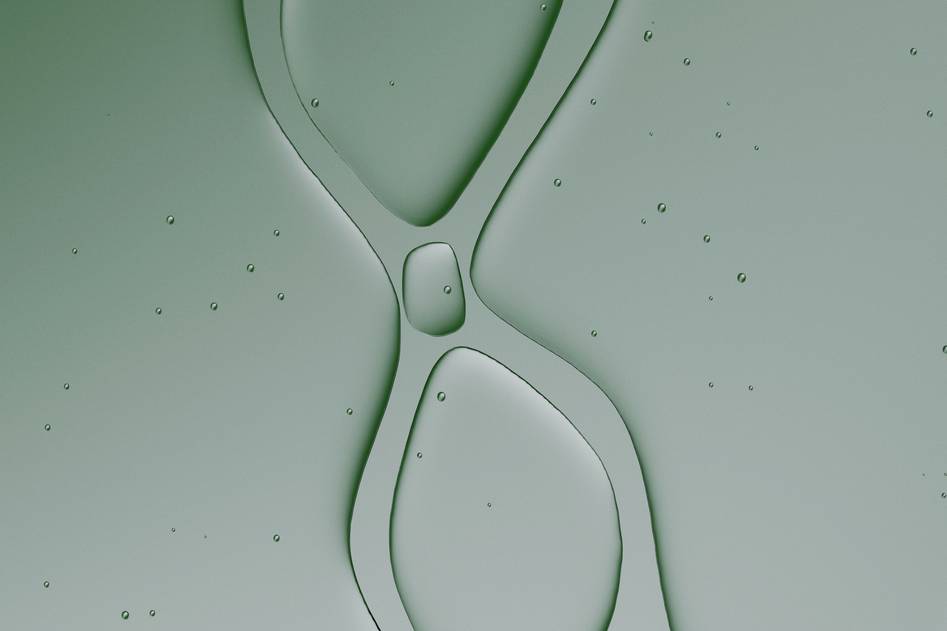 Close-up of clear hyaluronic acid gel texture with soft blue reflections on skincare surface