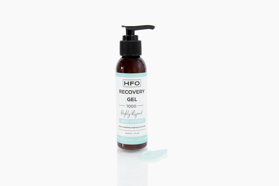 Minimal flat-lay of hyaluronic acid serum bottle beside fresh botanicals